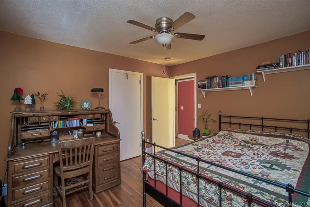18100 Barnhardt Road Davidson, NC 28036 - Photo 18 of 29 a bedroom with a bed and a chandelier
