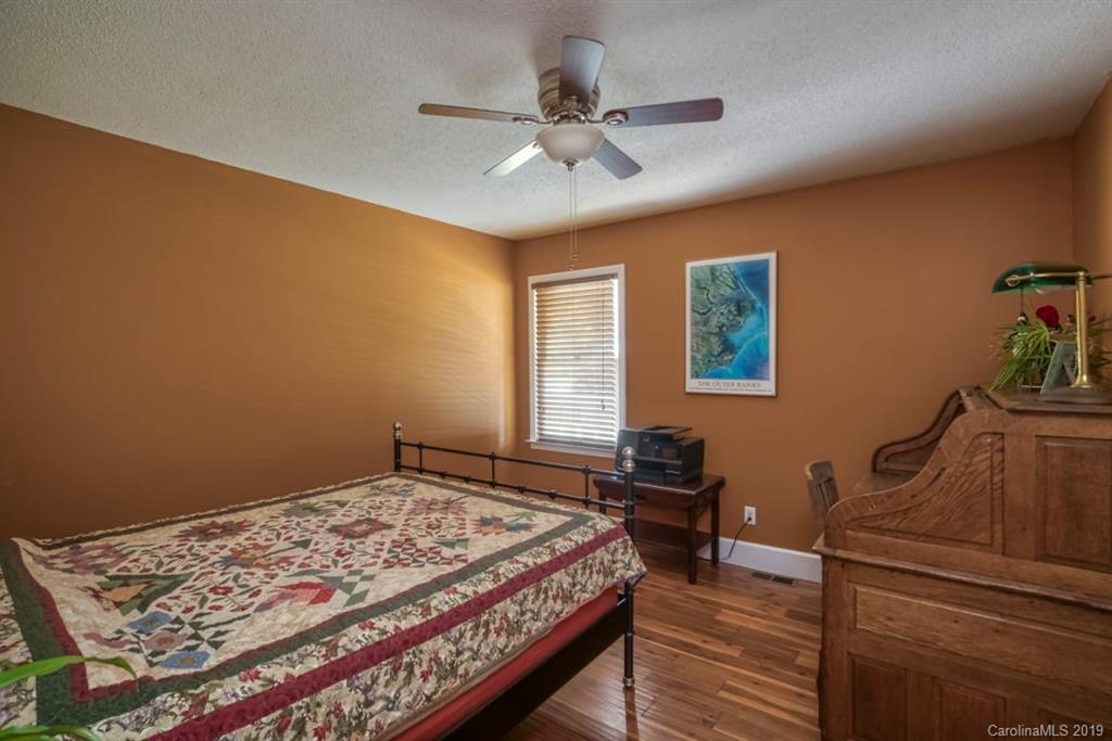 18100 Barnhardt Road Davidson, NC 28036 - Photo 19 of 29 a bedroom with a bed and a dresser