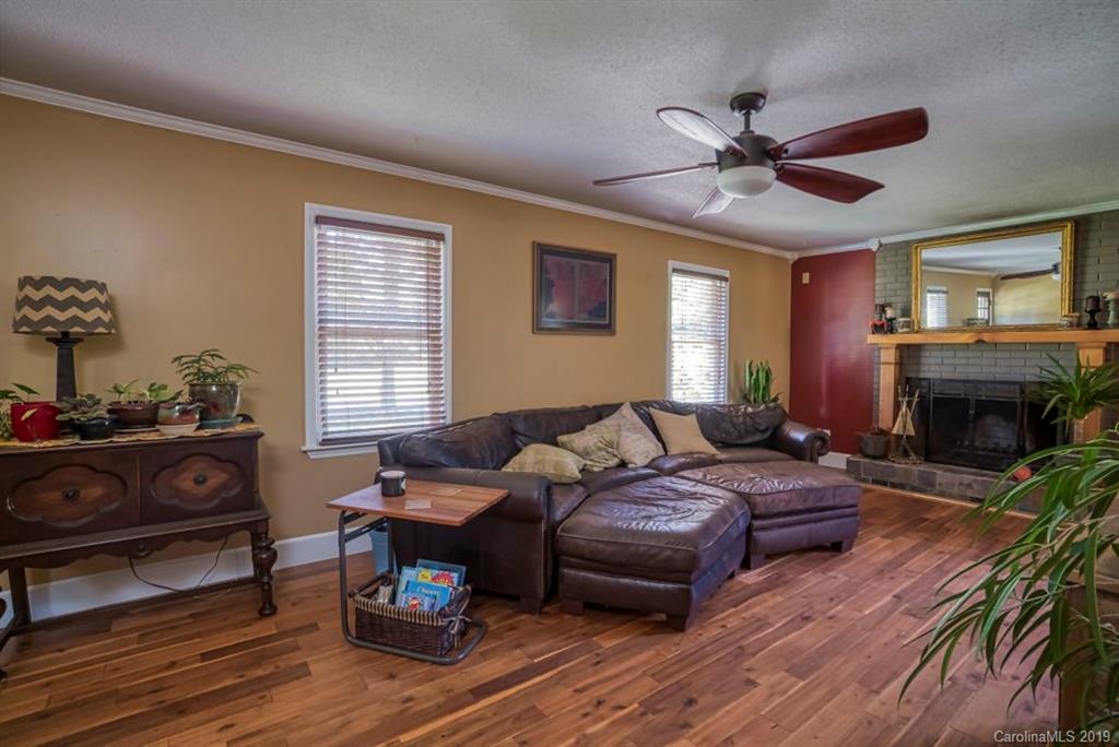 18100 Barnhardt Road Davidson, NC 28036 - Photo 5 of 29 a living room with furniture a fireplace and a window