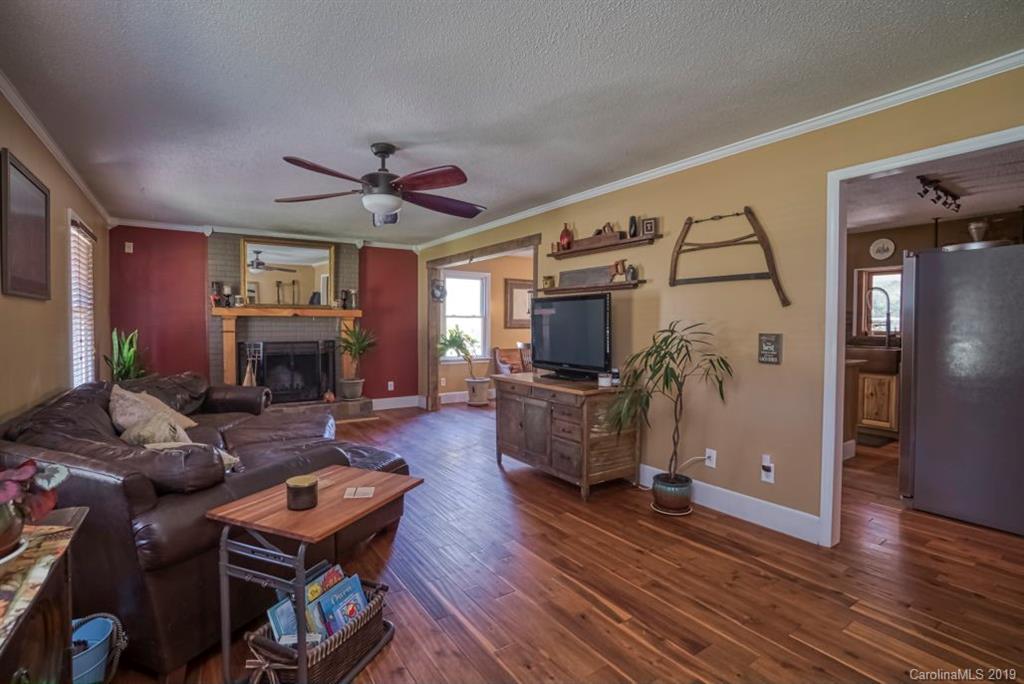 18100 Barnhardt Road Davidson, NC 28036 - Photo 7 of 29 a living room with furniture a flat screen tv and a fireplace