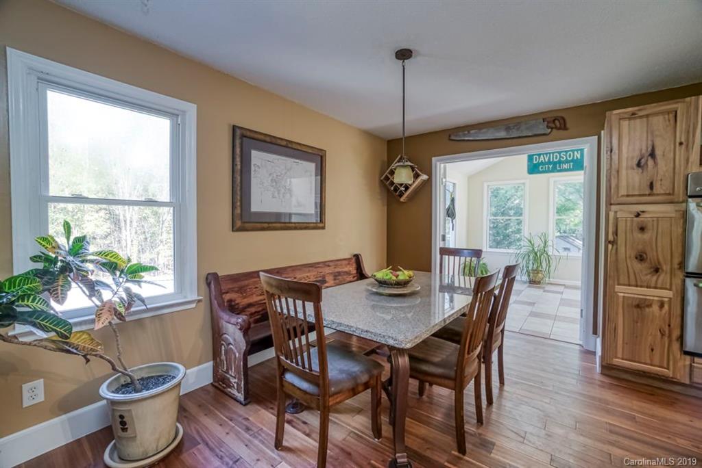 18100 Barnhardt Road Davidson, NC 28036 - Photo 8 of 29 a view of a dining room with furniture window and wooden floor