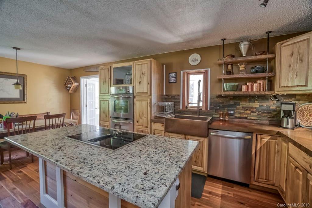 18100 Barnhardt Road Davidson, NC 28036 - Photo 9 of 29 a kitchen with stainless steel appliances granite countertop a stove a sink and a refrigerator