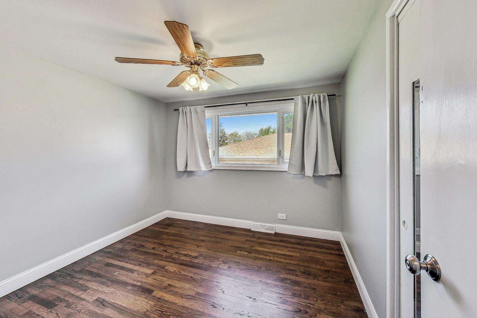 509 North Willow Road Elmhurst, IL 60126 - Photo 14 of 26 a view of an empty room with wooden floor and a window
