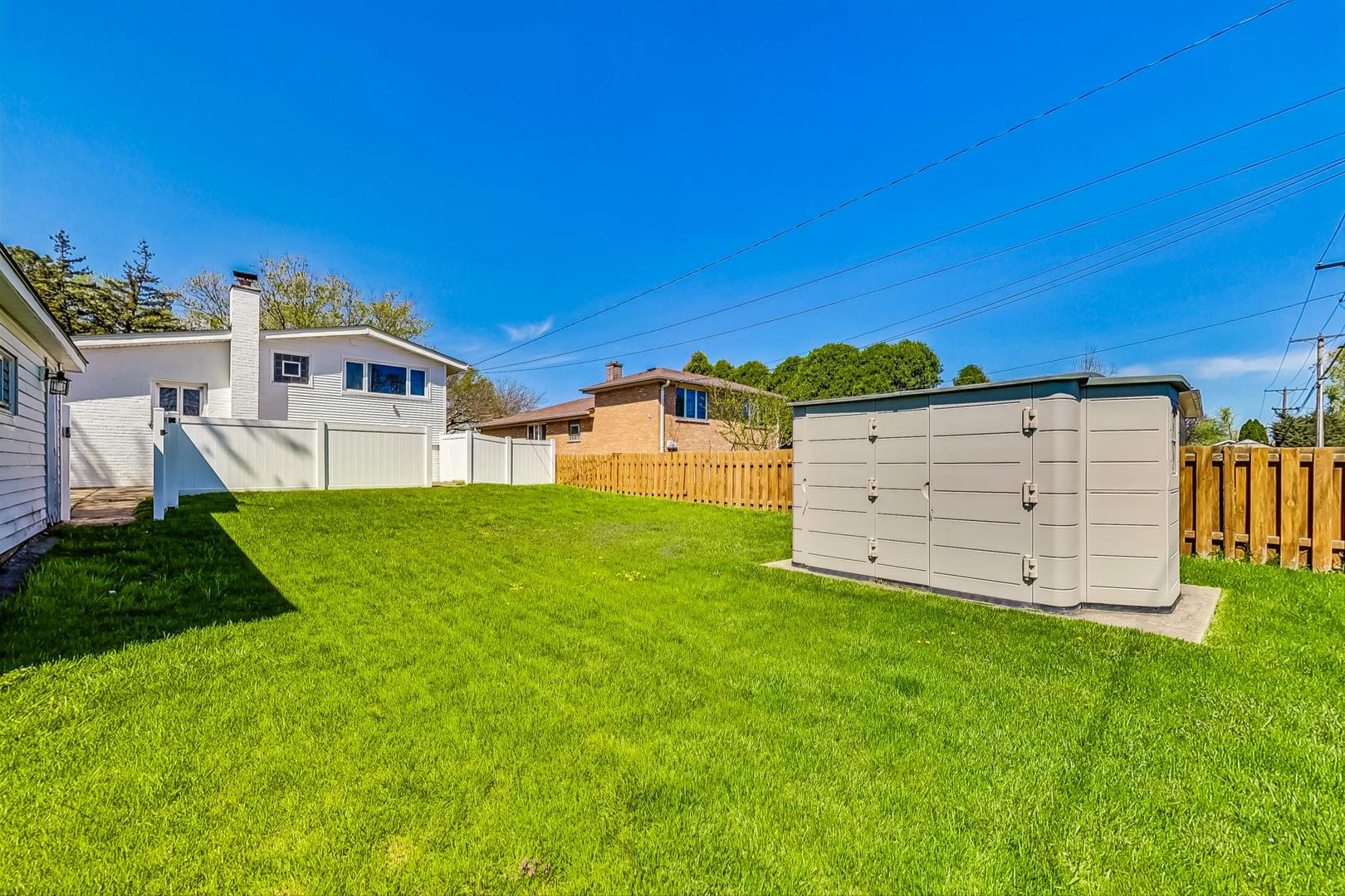 509 North Willow Road Elmhurst, IL 60126 - Photo 25 of 26 a view of a house with a big yard and large trees