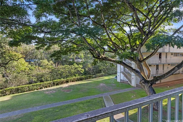 a view of a balcony with wooden fence
