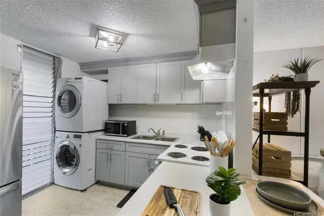 a kitchen with a sink a stove and cabinets