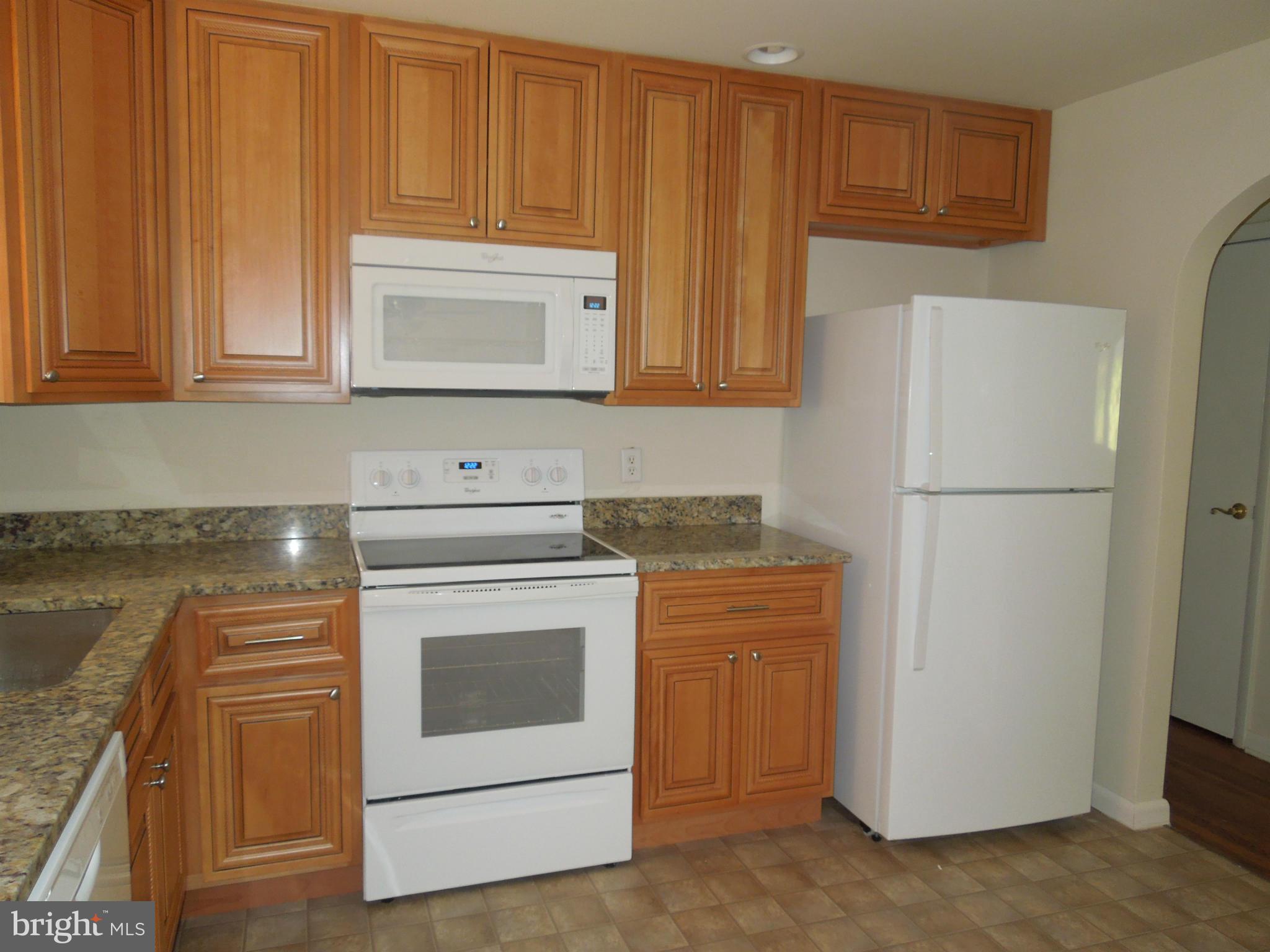 8457 New Cut Road Severn, MD 21144 - Photo 14 of 30 a kitchen with a stove a refrigerator and a sink