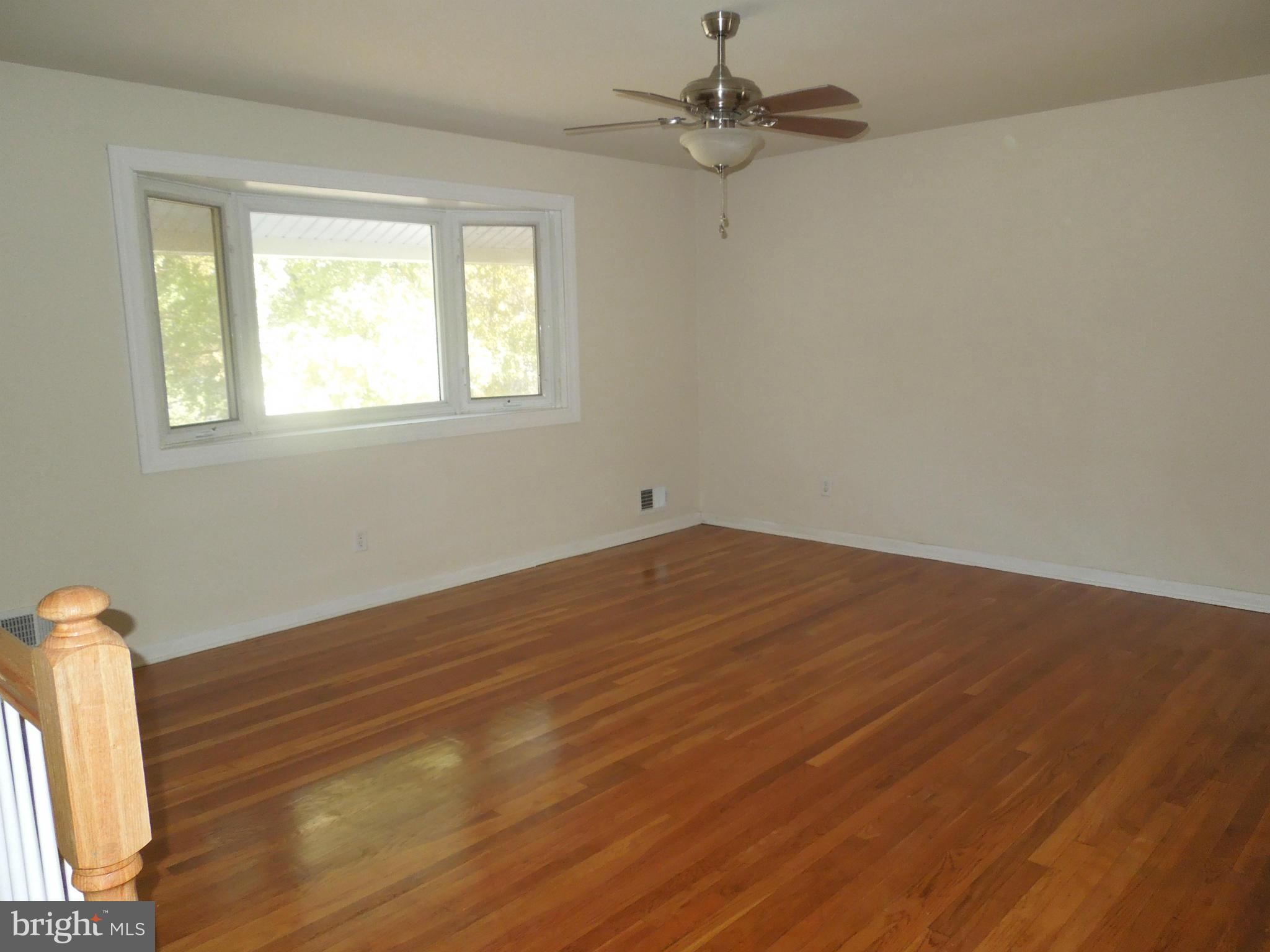 8457 New Cut Road Severn, MD 21144 - Photo 8 of 30 a view of empty room with wooden floor and fan