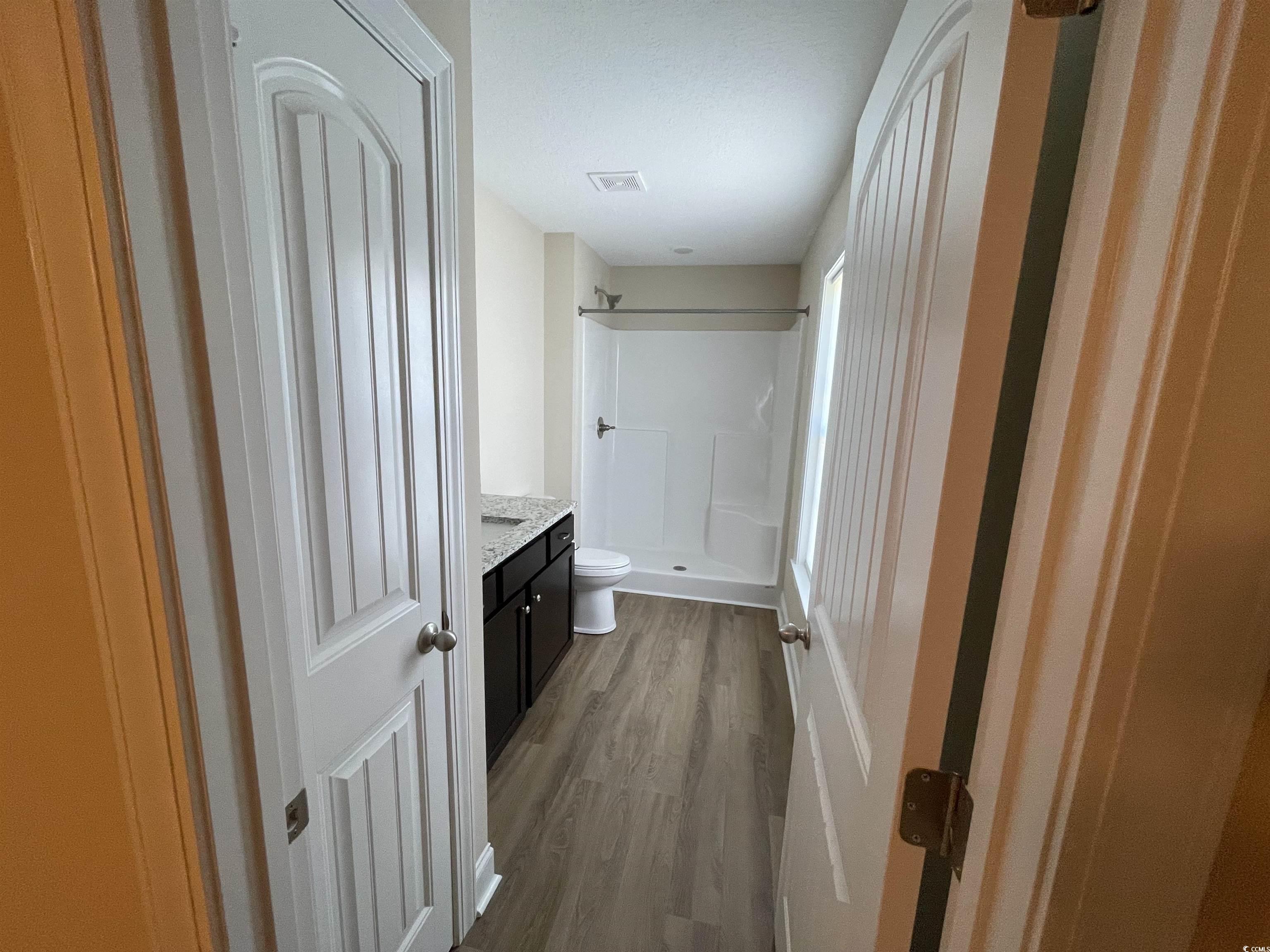 6765 Highway 66 Loris, SC 29569 - Photo 12 of 20 Bathroom featuring visible vents, toilet, wood fin