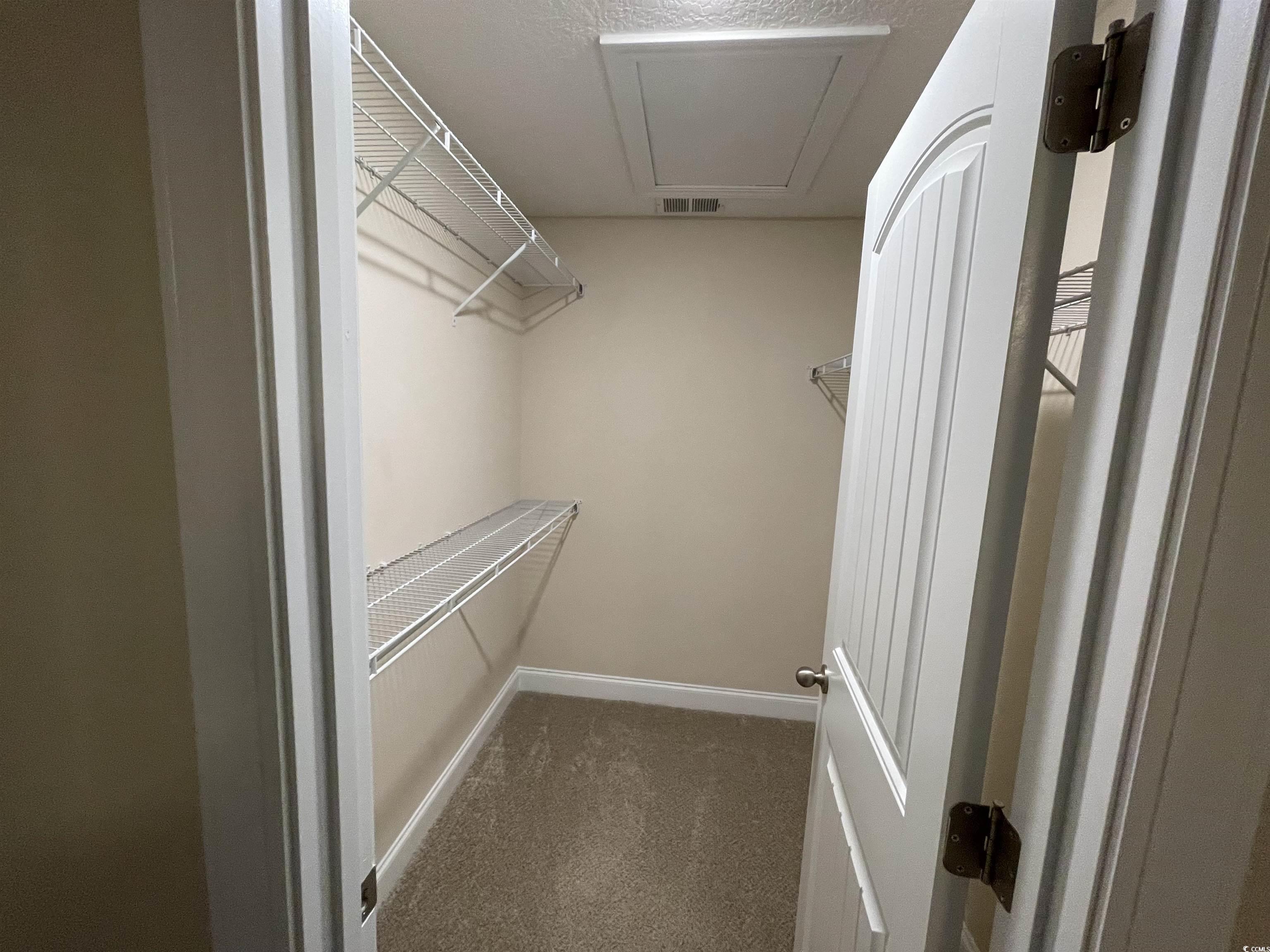 6765 Highway 66 Loris, SC 29569 - Photo 14 of 20 Spacious closet featuring visible vents and dark c