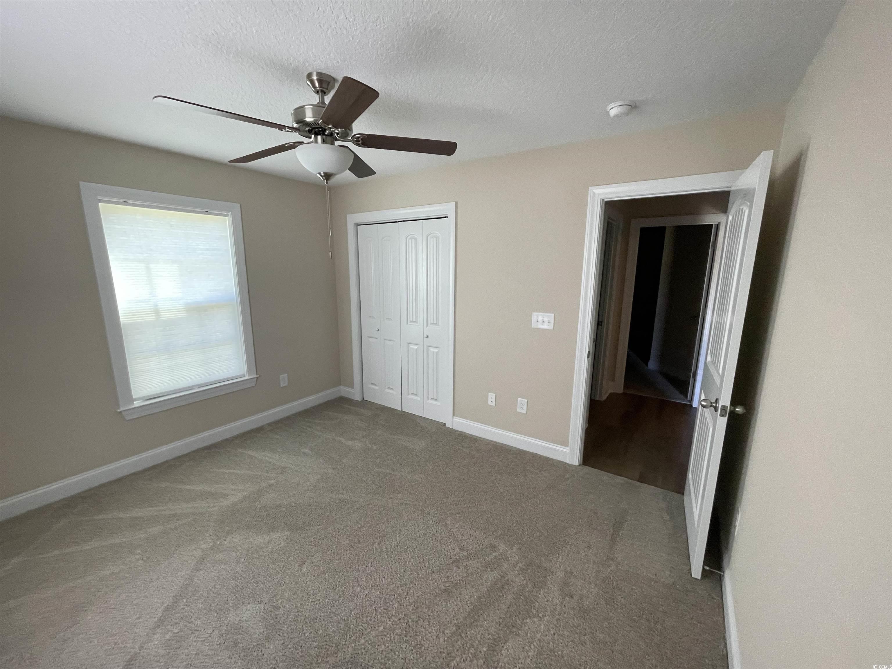 6765 Highway 66 Loris, SC 29569 - Photo 15 of 20 Unfurnished bedroom with baseboards, ceiling fan,