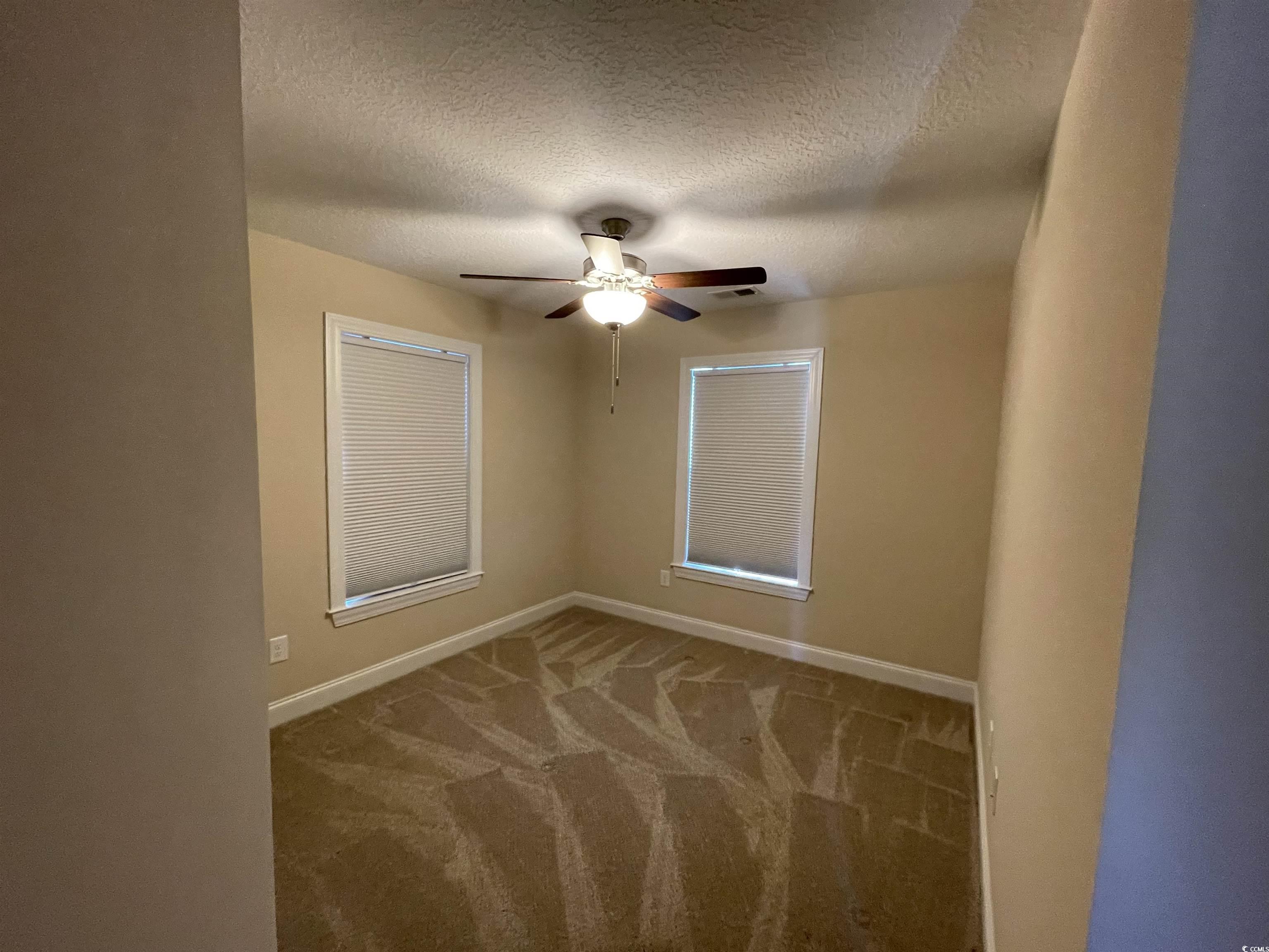 6765 Highway 66 Loris, SC 29569 - Photo 17 of 20 Unfurnished room with ceiling fan, a textured ceil