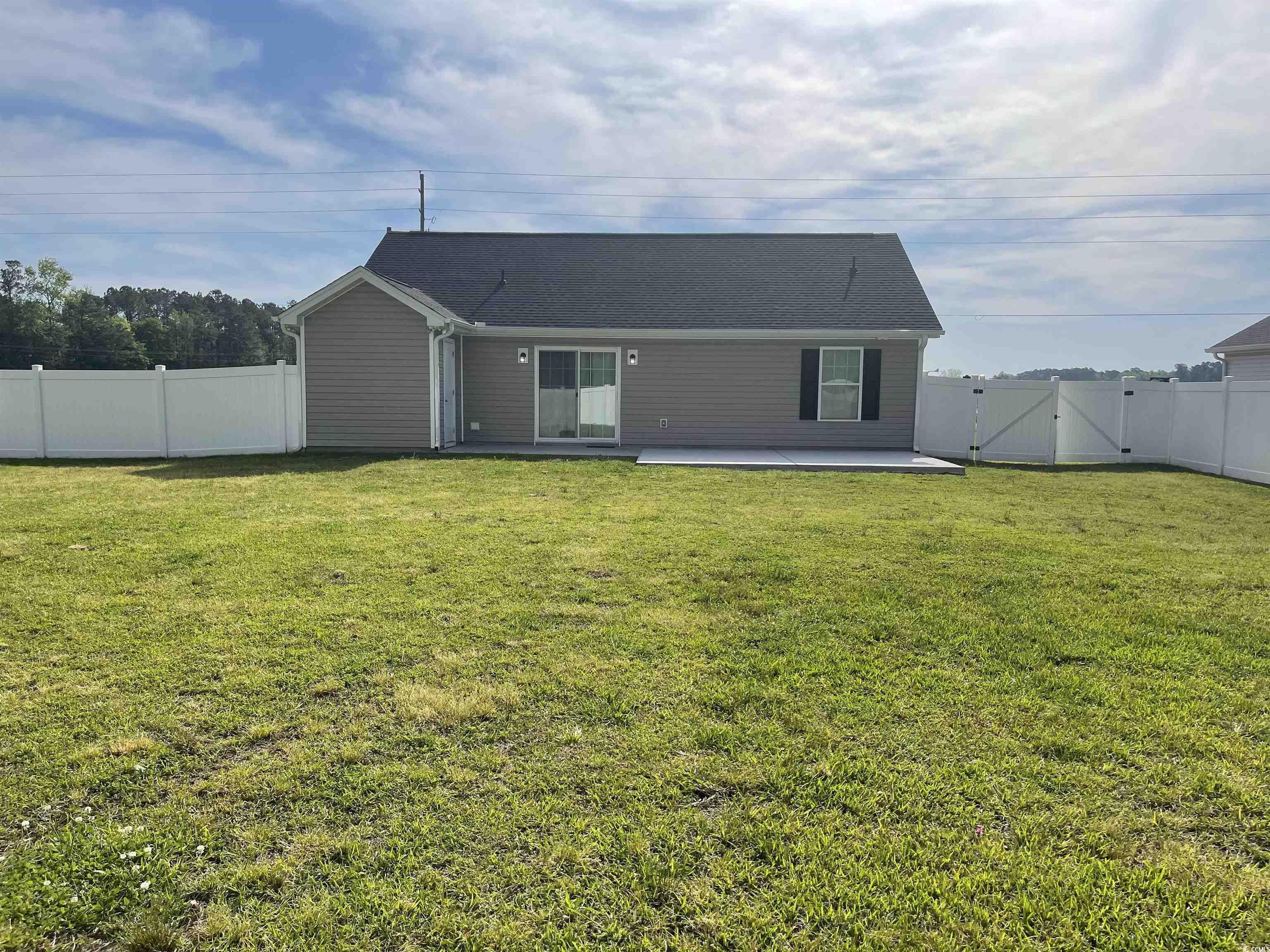 6765 Highway 66 Loris, SC 29569 - Photo 2 of 20 Rear view of property featuring a lawn, a patio ar