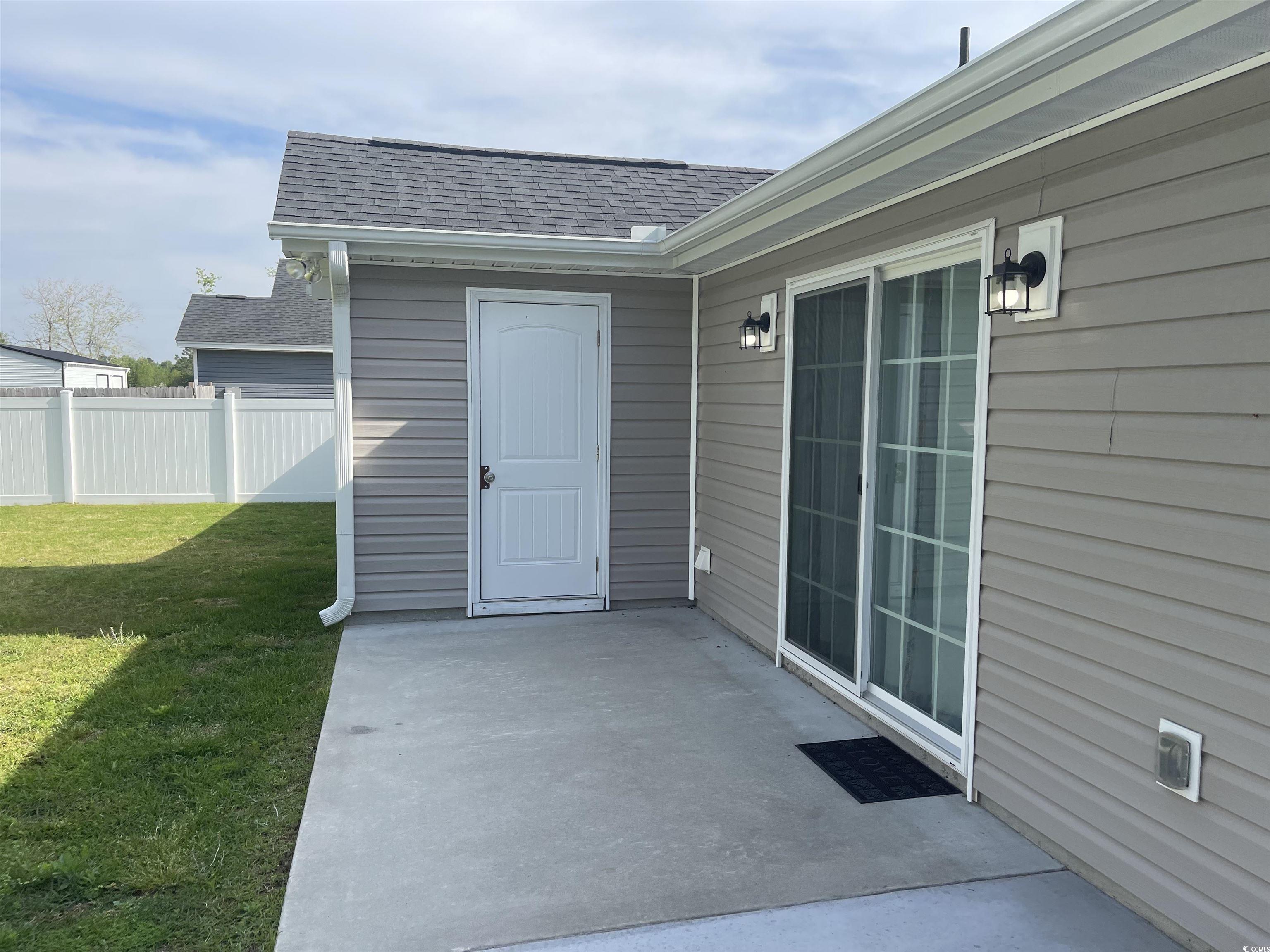 6765 Highway 66 Loris, SC 29569 - Photo 3 of 20 View of rear patio and entry with a shingled roof,