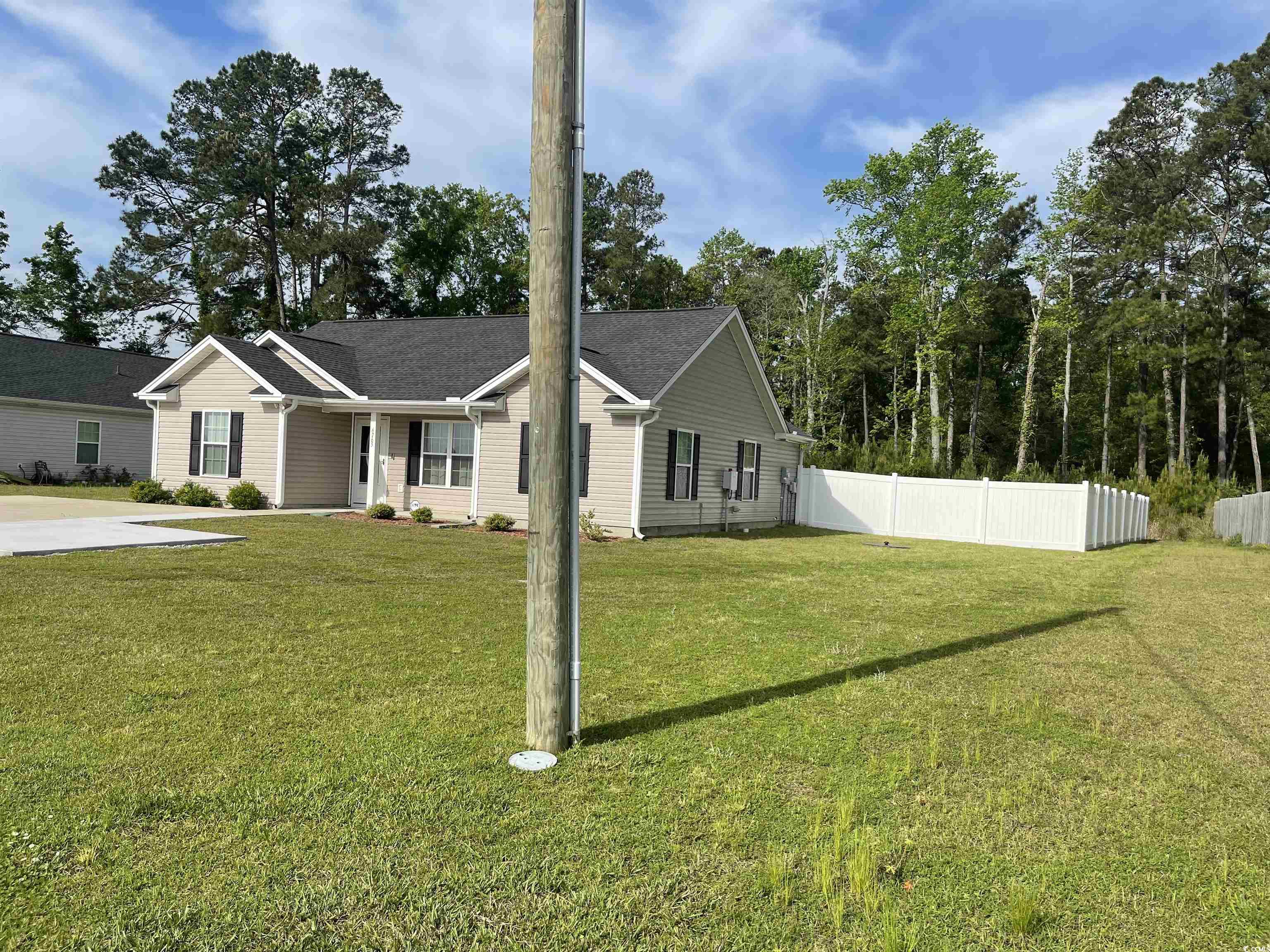 6765 Highway 66 Loris, SC 29569 - Photo 5 of 20 View of front facade with fence and a front lawn
