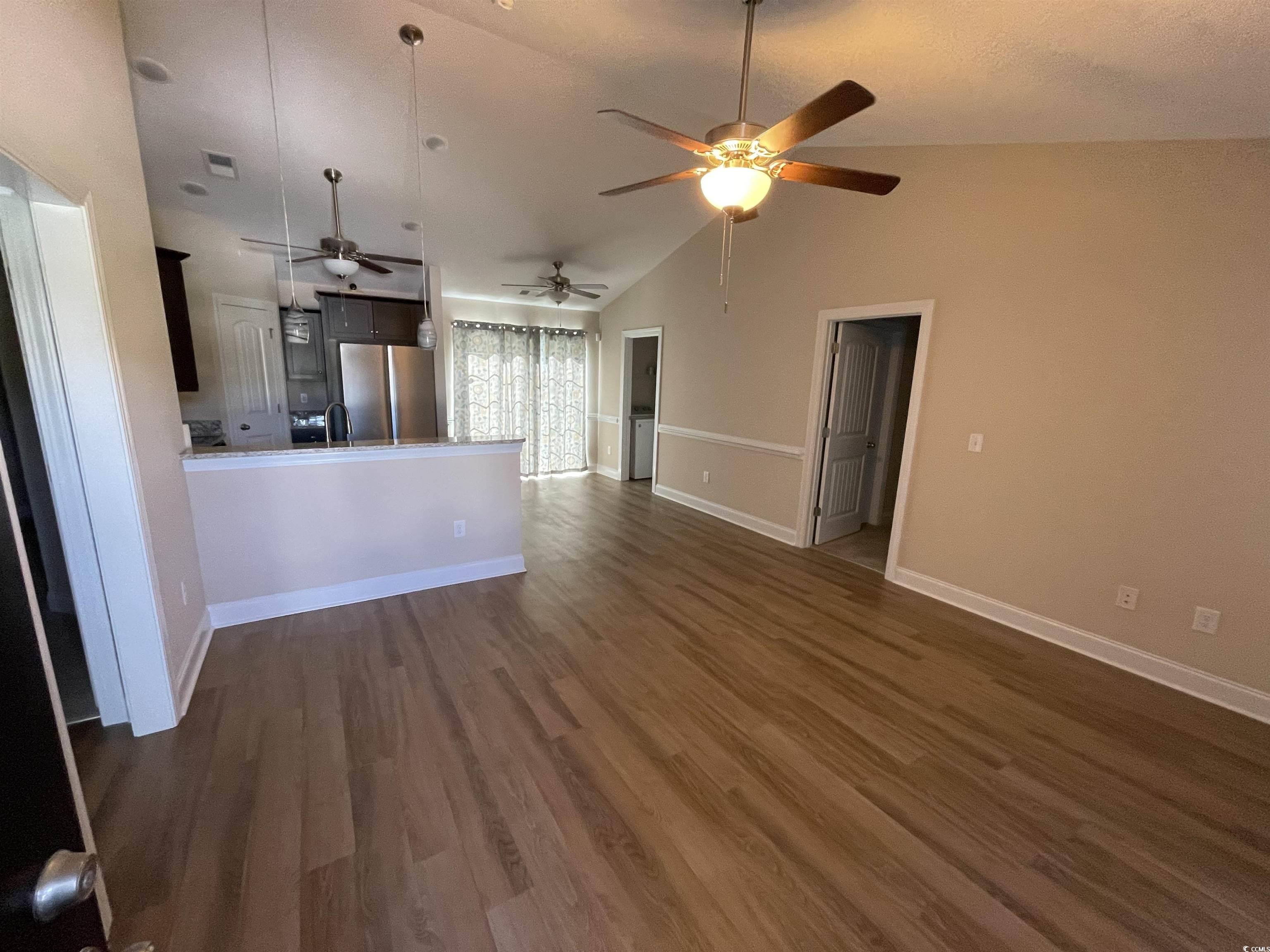 6765 Highway 66 Loris, SC 29569 - Photo 7 of 20 Unfurnished living room featuring baseboards, vaul