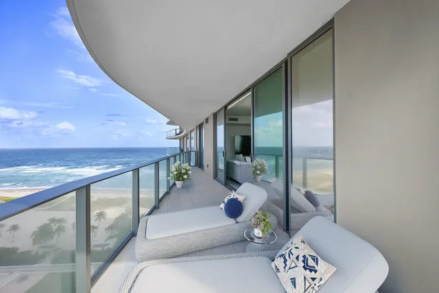 a hallway with furniture and a large window