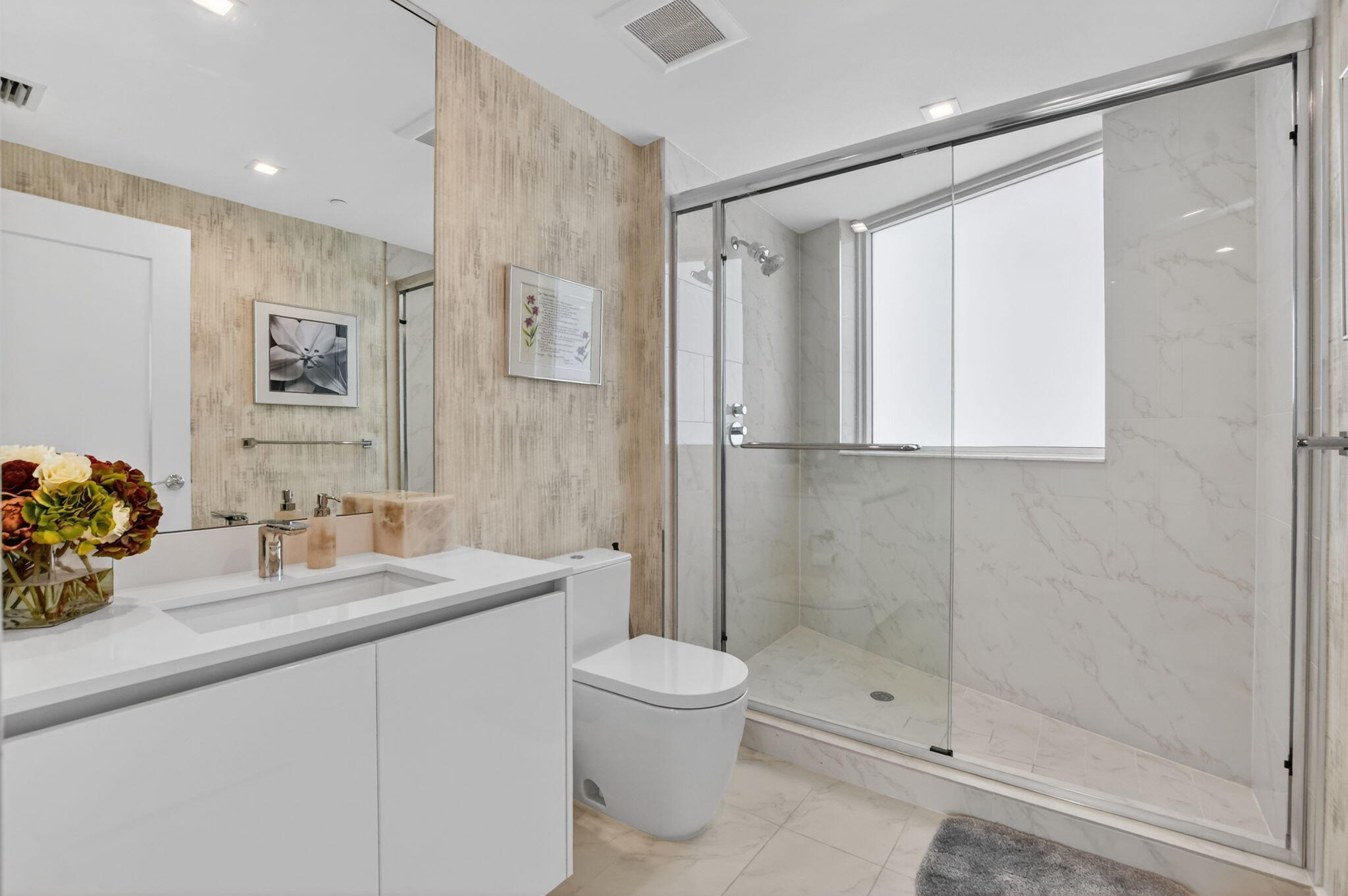 20155 Boca W Drive, Unit B701 Boca Raton, FL 33434 - Photo 34 of 78 a bathroom with a double vanity sink toilet and shower