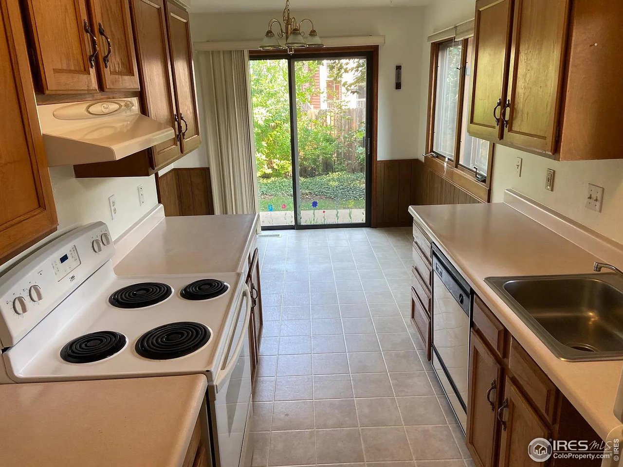 4885 Eisenhower Drive Boulder, CO 80303 - Photo 3 of 9 a kitchen with a sink a stove and a microwave