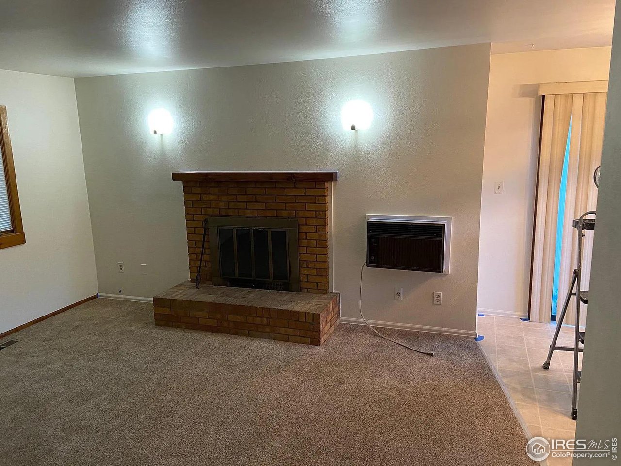 4885 Eisenhower Drive Boulder, CO 80303 - Photo 4 of 9 a living room with furniture and a fireplace