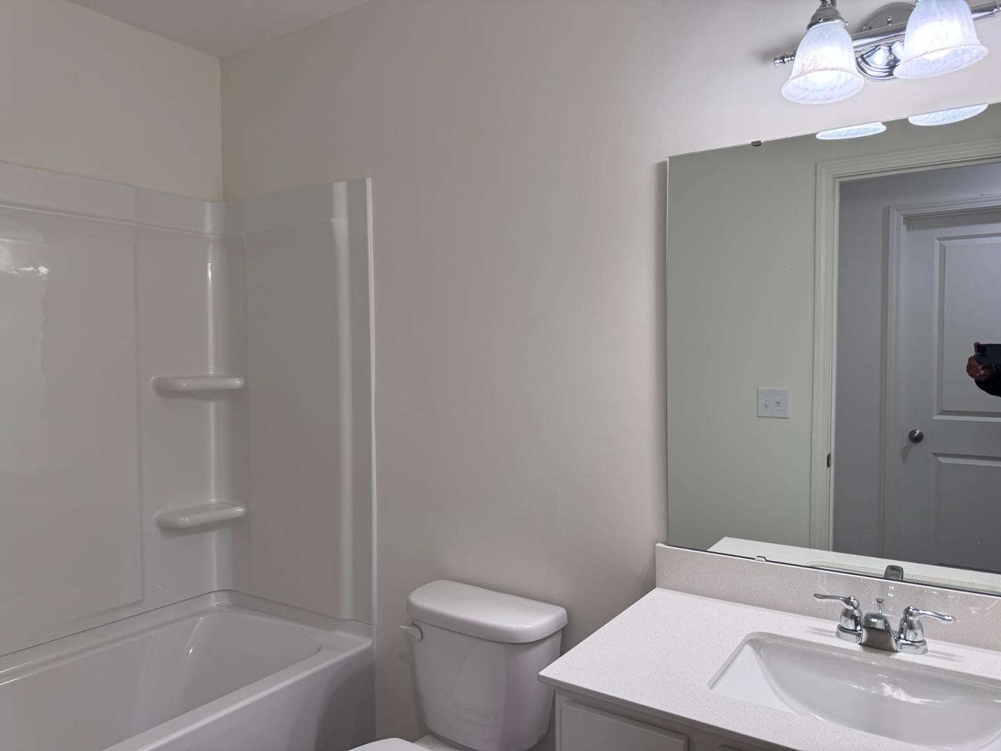 2002 Trailside Drive Durham, NC 27704 - Photo 12 of 14 a bathroom with a sink a toilet and shower