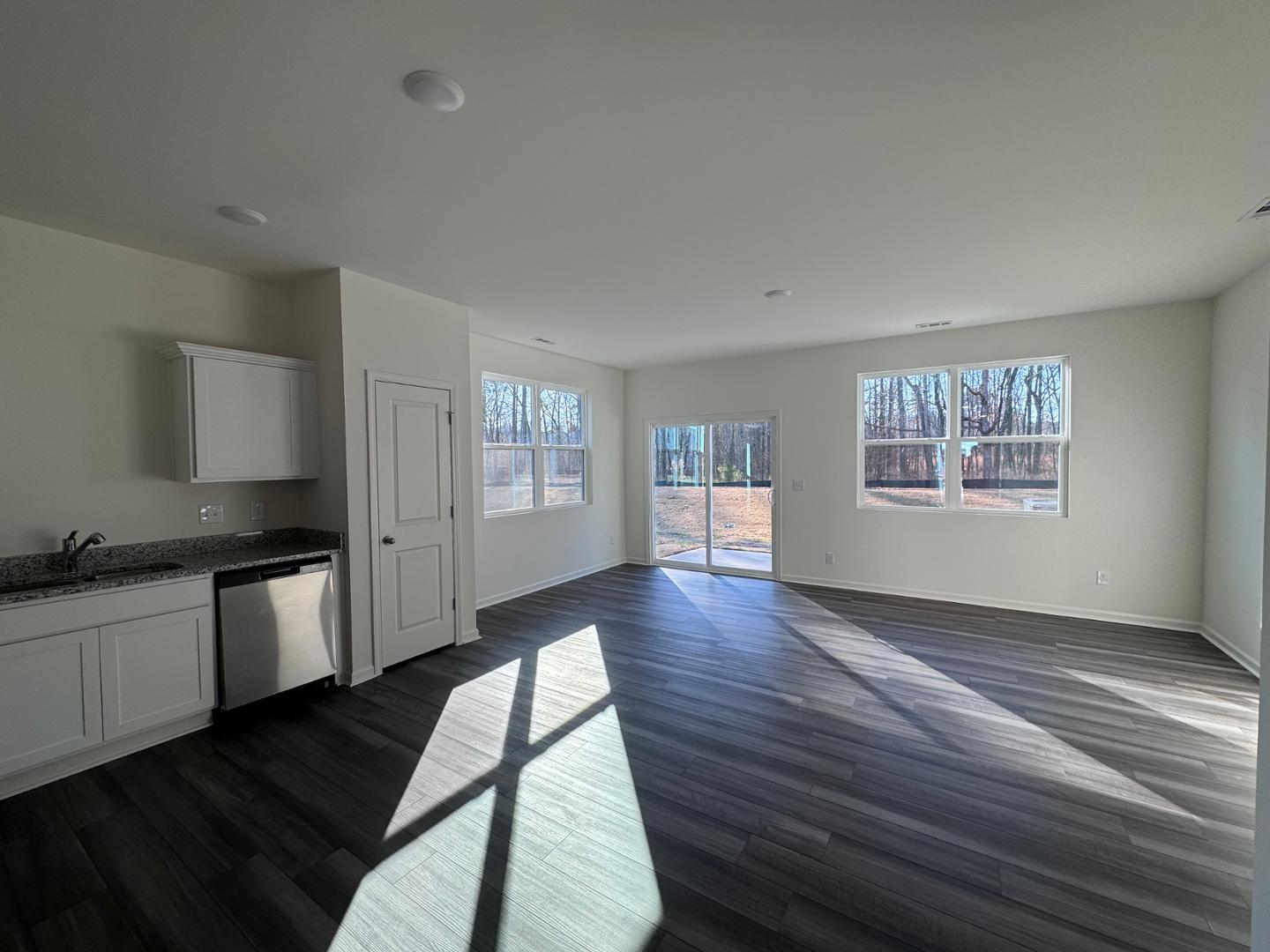 2002 Trailside Drive Durham, NC 27704 - Photo 2 of 14 a open kitchen with granite countertop a stove top oven a sink and dishwasher with wooden floor