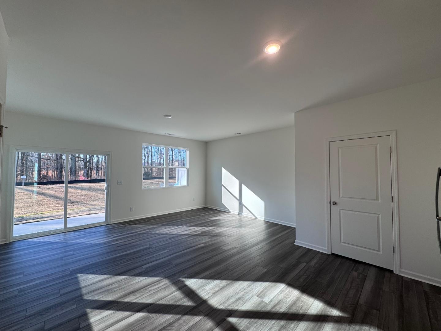 2002 Trailside Drive Durham, NC 27704 - Photo 4 of 14 a view of an empty room with window and wooden floor
