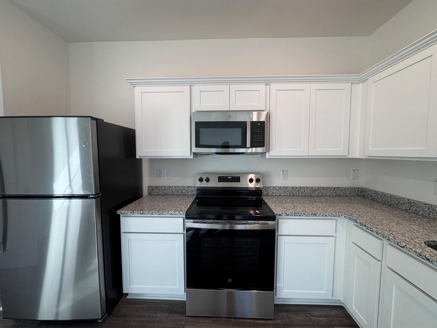 2002 Trailside Drive Durham, NC 27704 - Photo 7 of 14 a kitchen with a refrigerator stove and microwave