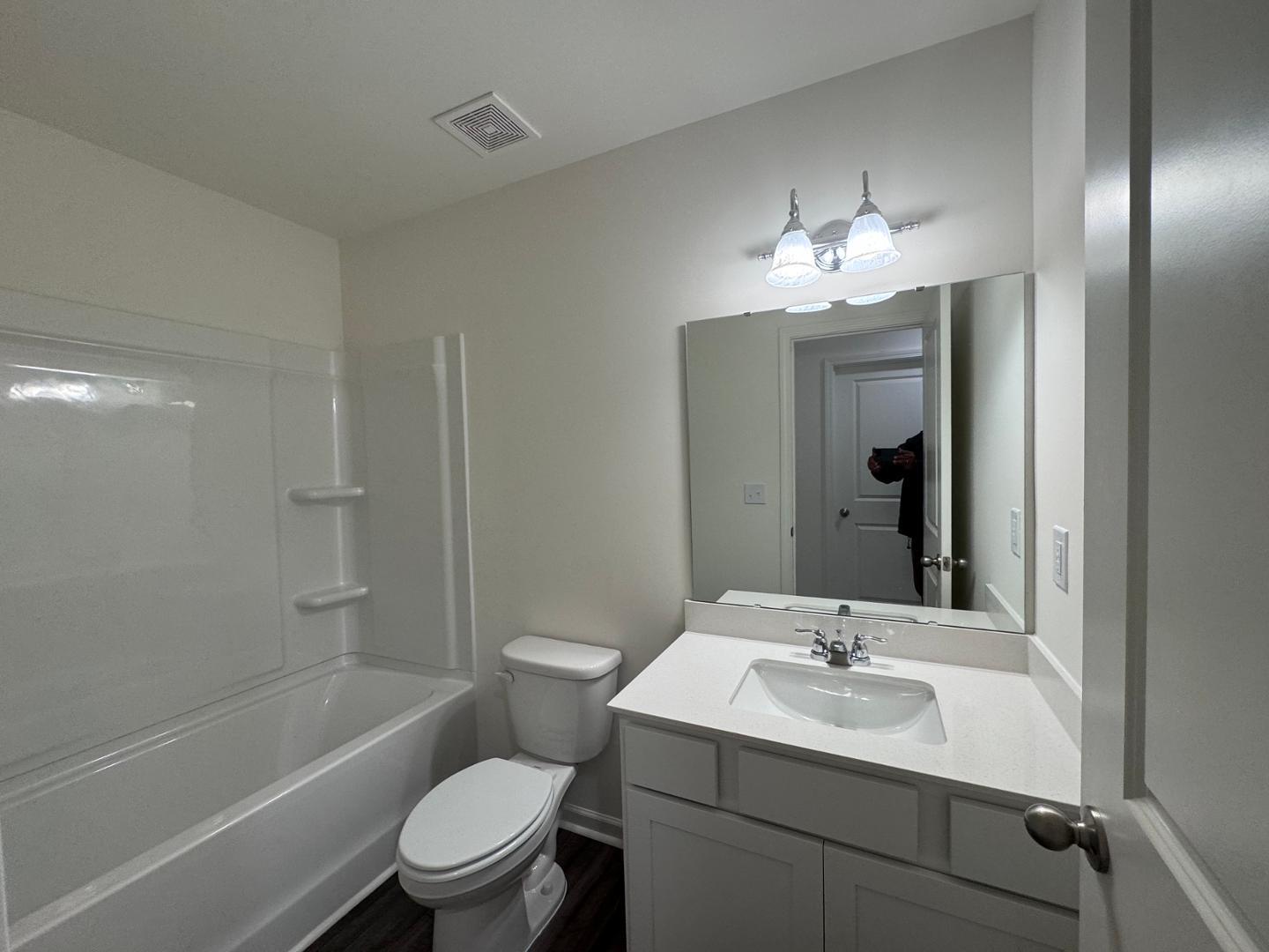 2002 Trailside Drive Durham, NC 27704 - Photo 9 of 14 a bathroom with a toilet a sink a mirror a bathtub and vanity