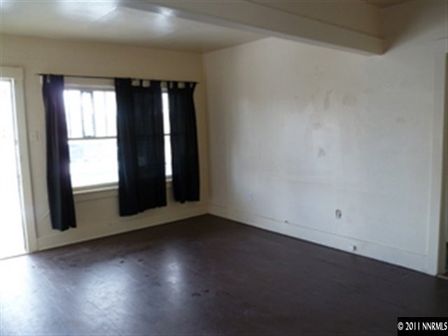760 Mill Street Reno, NV 89502 - Photo 2 of 5 an empty room with wooden floor and windows