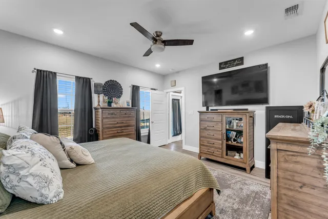 a bedroom with a bed and a flat screen tv