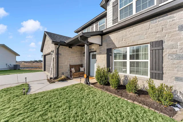 a view of a house with yard and sitting area