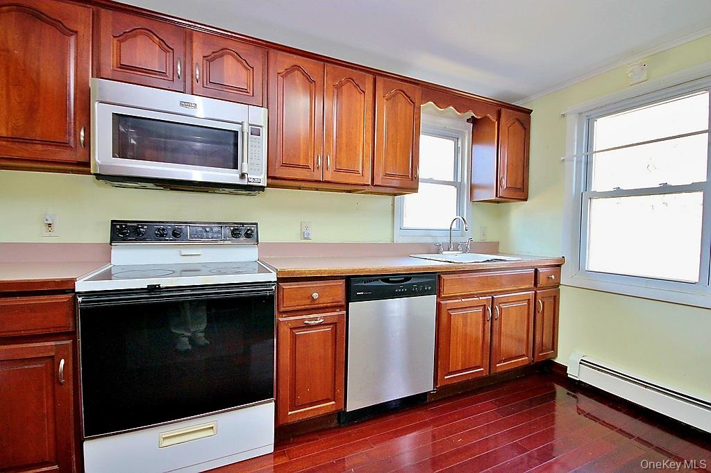 491 Hurd Road Swan Lake, NY 12783 - Photo 12 of 30 a kitchen with stainless steel appliances granite countertop a sink and a microwave