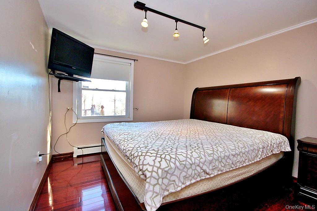 491 Hurd Road Swan Lake, NY 12783 - Photo 15 of 30 a bedroom with a bed and flat screen tv