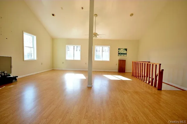 a view of a room with wooden floor and window
