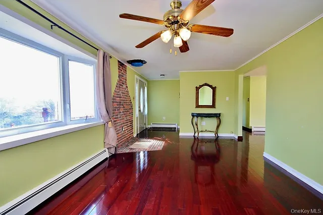 a view of a room with furniture and a large window