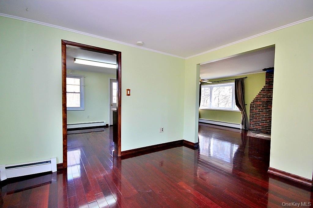 491 Hurd Road Swan Lake, NY 12783 - Photo 8 of 30 a view of empty room with wooden floor and fan