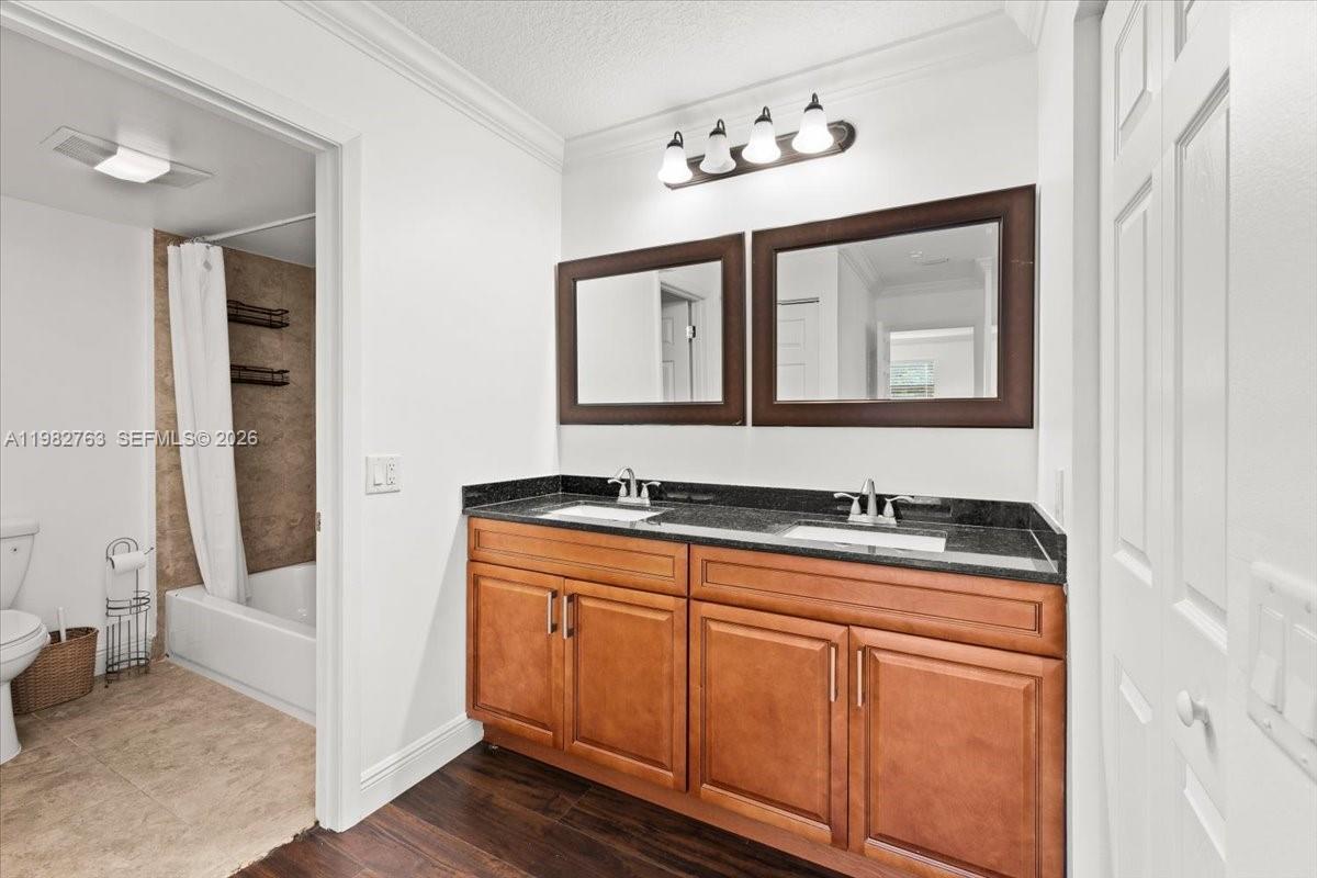 7944 Eastlake Drive, Unit D Boca Raton, FL 33433 - Photo 18 of 29 a bathroom with a granite countertop sink a mirror and a