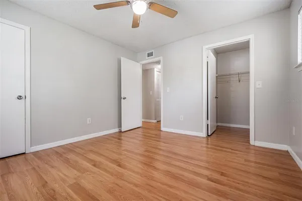 a view of an empty room with wooden floor