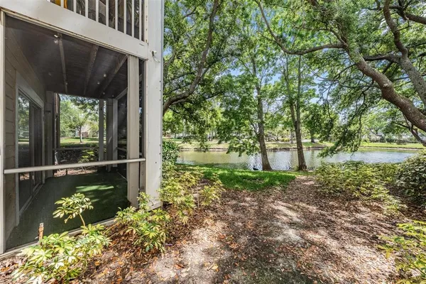 a backyard of a house with a yard and outdoor seating
