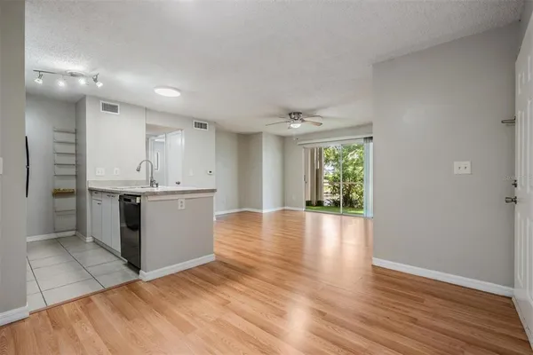 a view of a kitchen with wooden floor and a window