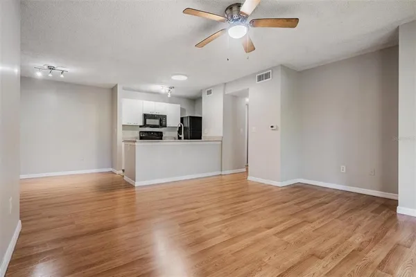 a view of a kitchen with a dishwasher cabinets and wooden floor