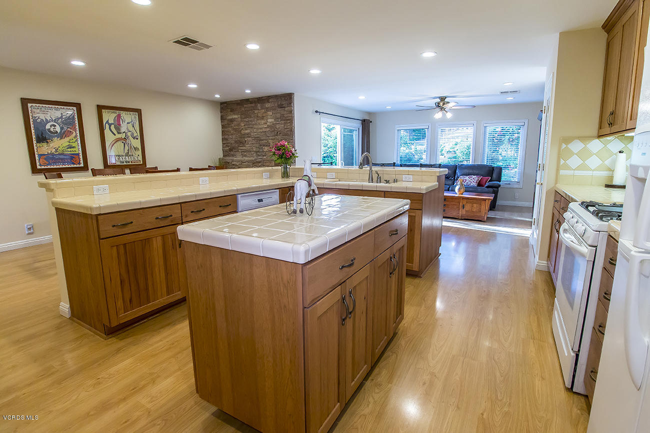 1333 Rambling Road Simi Valley, CA 93065 - Photo 22 of 49 a kitchen with stainless steel appliances granite countertop a lot of counter space and wooden floors
