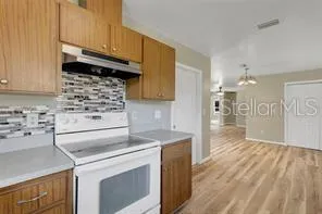 a kitchen with a stove and a refrigerator
