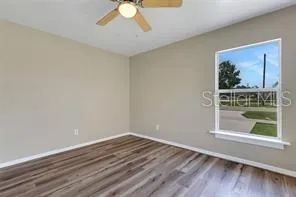 a view of a room with wooden floor and window