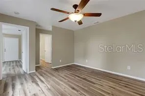 a view of an empty room with wooden floor