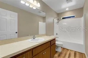 a bathroom with a sink double vanity granite tub shower and a mirror