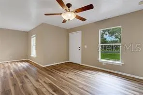 wooden floor in an empty room with a window