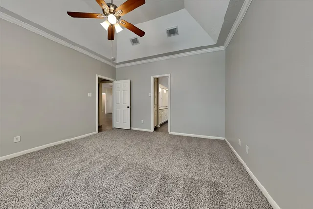 an empty room with closet and a chandelier fan