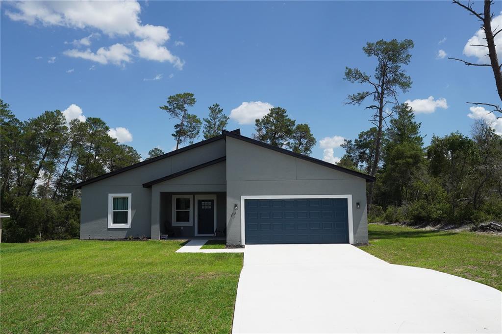 2914 Southwest 162nd Street Road Ocala, FL 34473 - Photo 1 of 47 a front view of a house with a yard